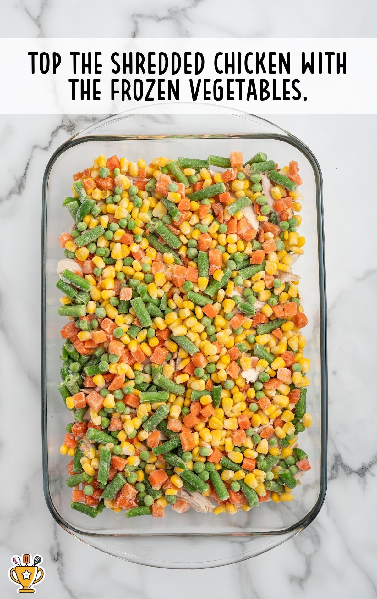 frozen vegetables are spread evenly over the chicken.