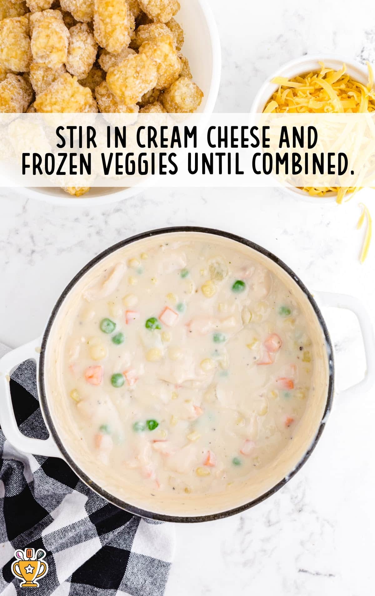 stirring in cream cheese and frozen veggies in a bowl