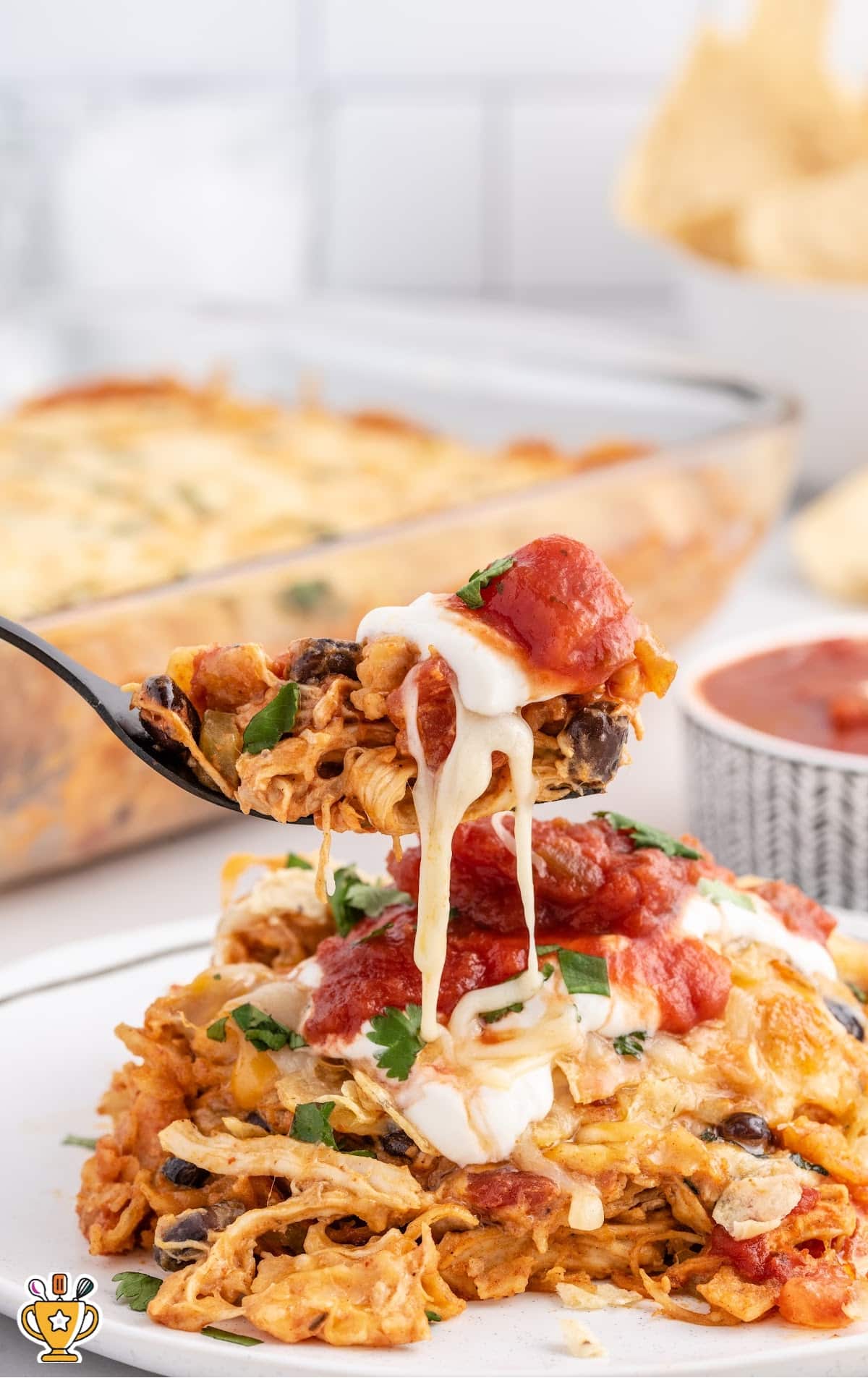 Chicken Taco Casserole on a plate with a spoon holding some of it