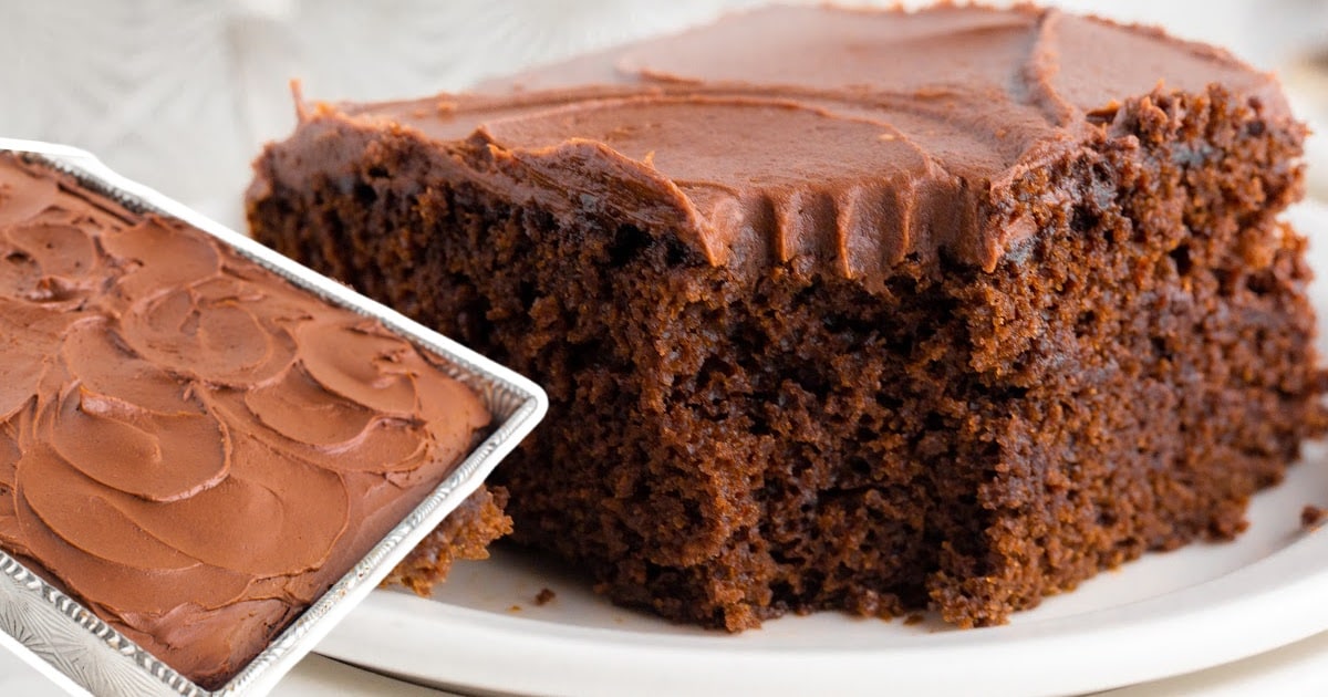 A cake in a cake pan next to a slice on a plate.