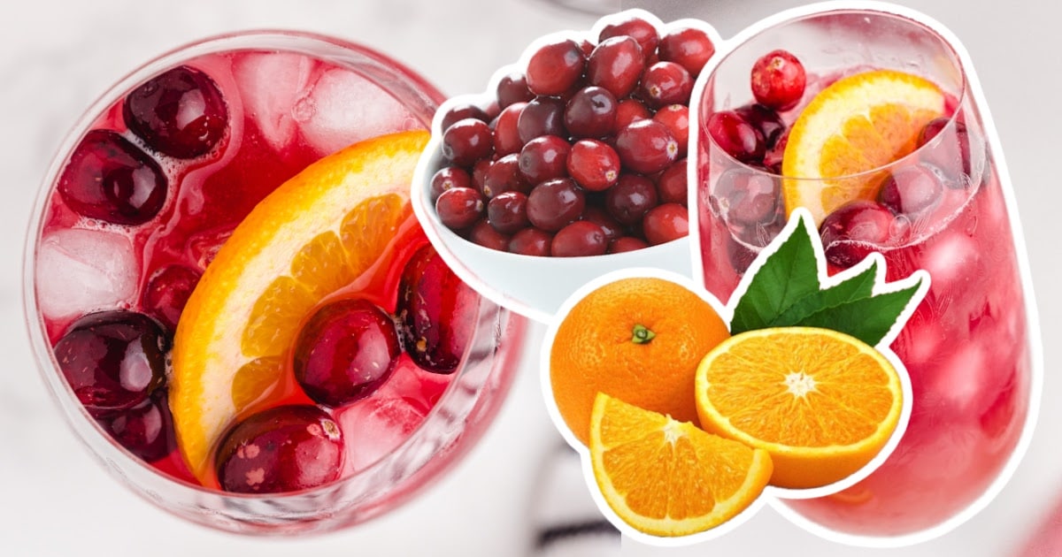 Glasses of punch with cranberries and orange slices.