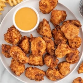 Copycat Chick Fil A Nuggets on a plate with a bowl of sauce