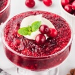 Cranberry Jello Salad in a glass, with a some cranberry on top