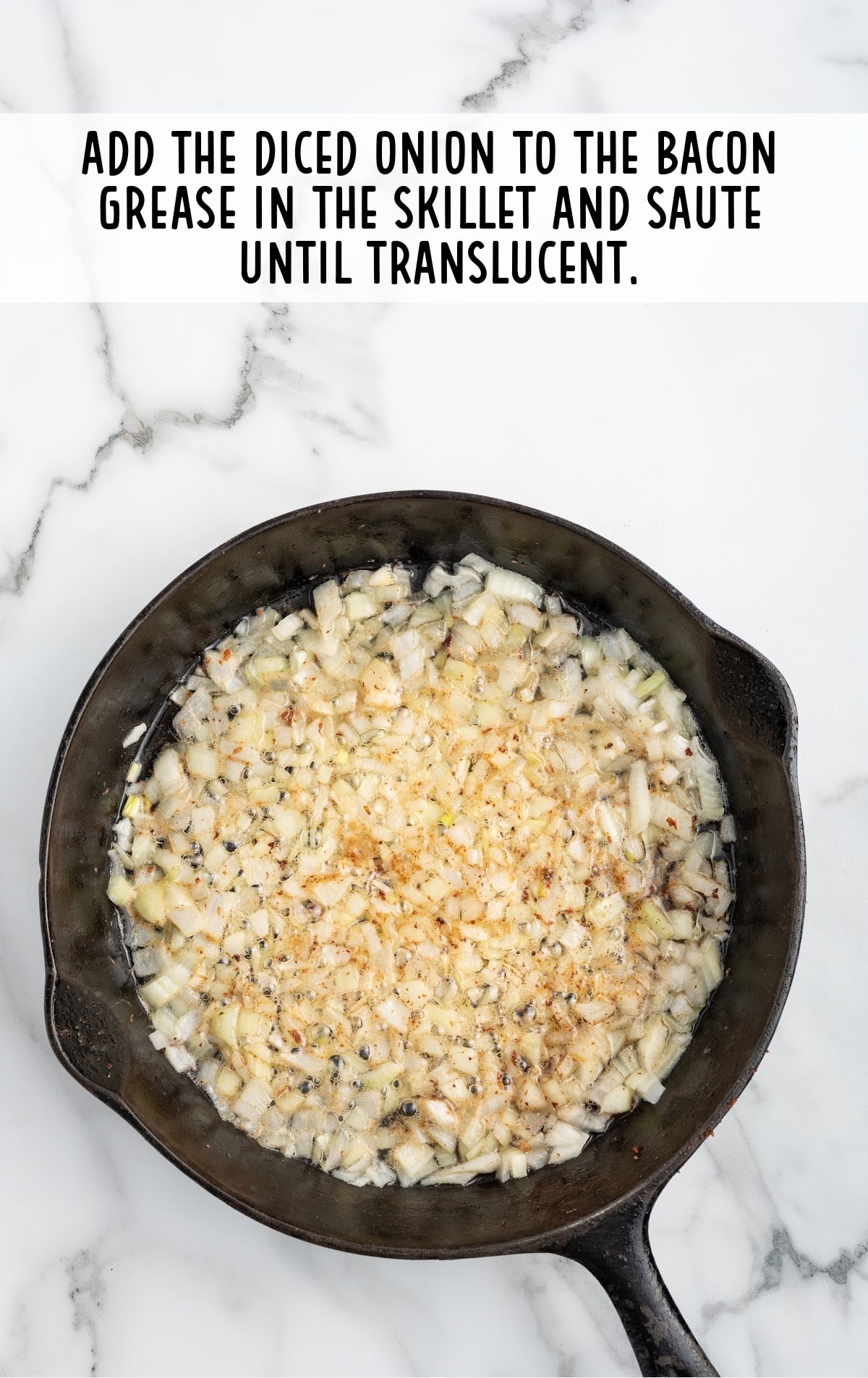 diced onion and bacon grease in the skillet