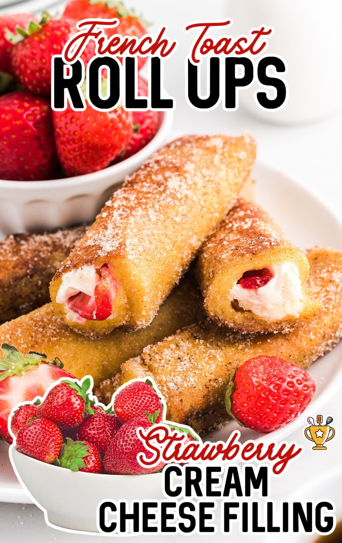 French Toast Roll Ups on a plate and bowl of strawberries on the side