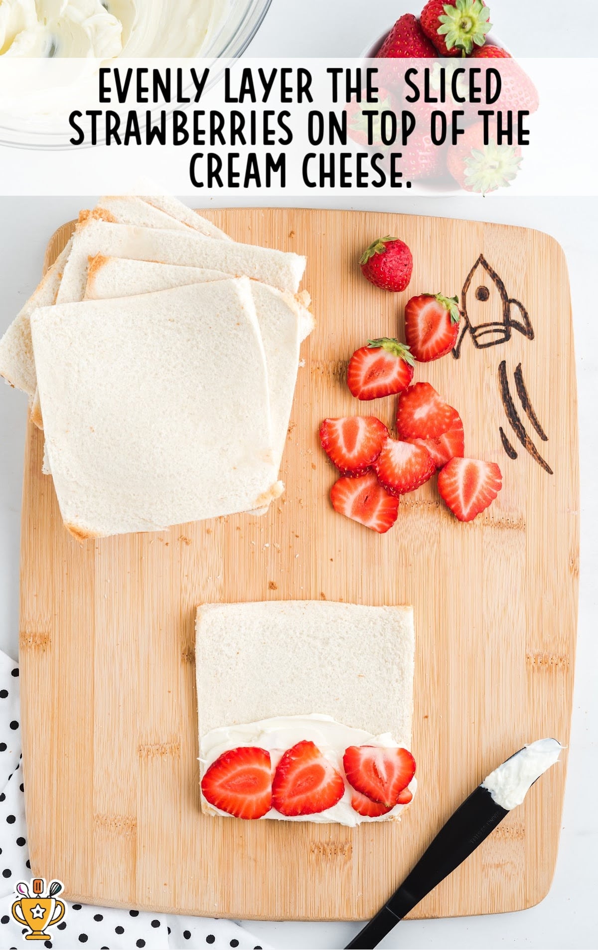 sliced strawberries layered on top of cream cheese on bread slices
