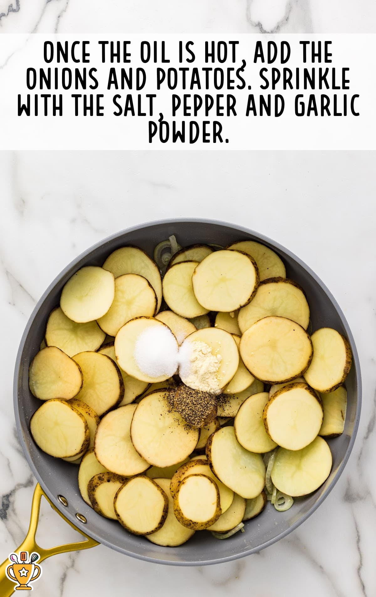 onions and potatoes sprinkled with salt, pepper and garlic in a frying pan