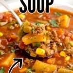 A bowl of soup with a spoon in it.