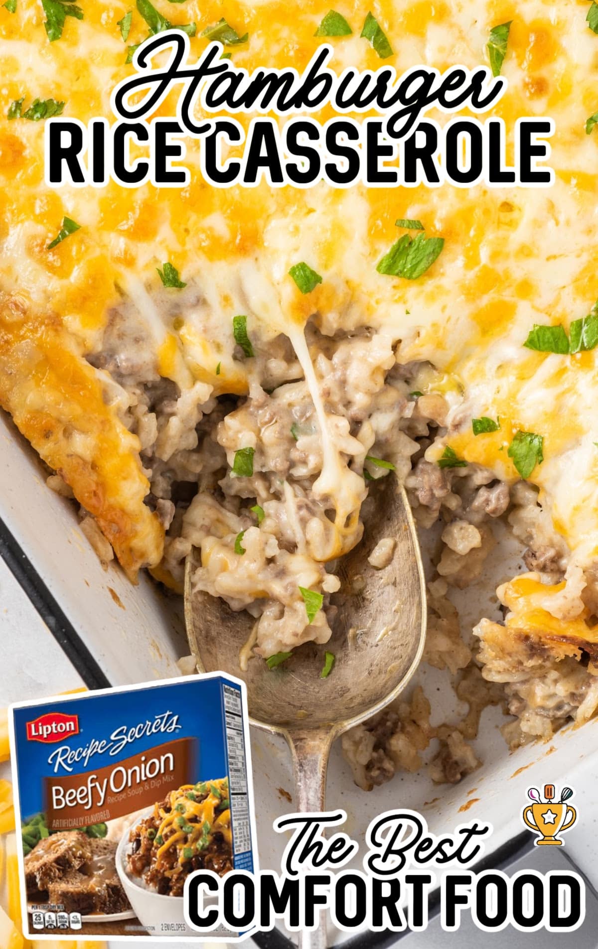 a white baking dish full of cheesy Hamburger Rice Casserole with a serving spoon in it.