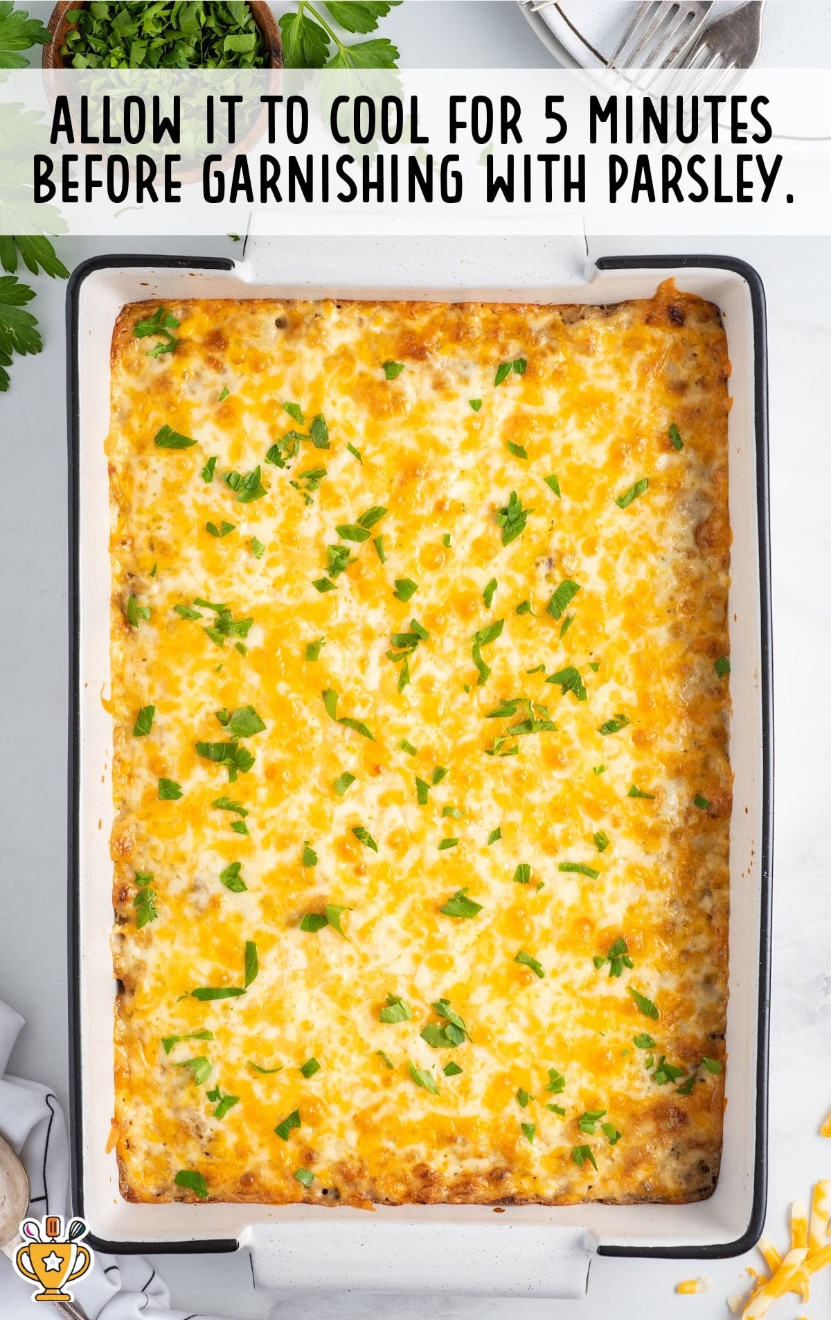 a white casserole dish covered in melted cheese