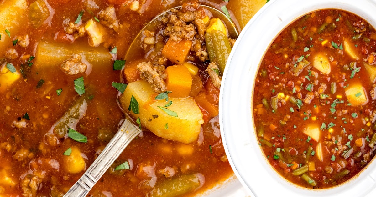 A spoon full of Hamburger Soup Crockpot, and a Crockpot full of the soup