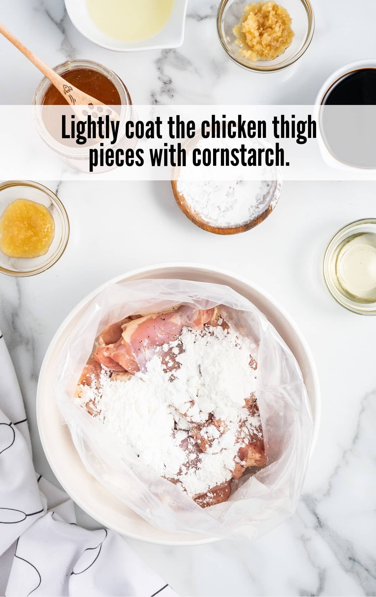 chicken thighs covered with cornstarch in a bowl