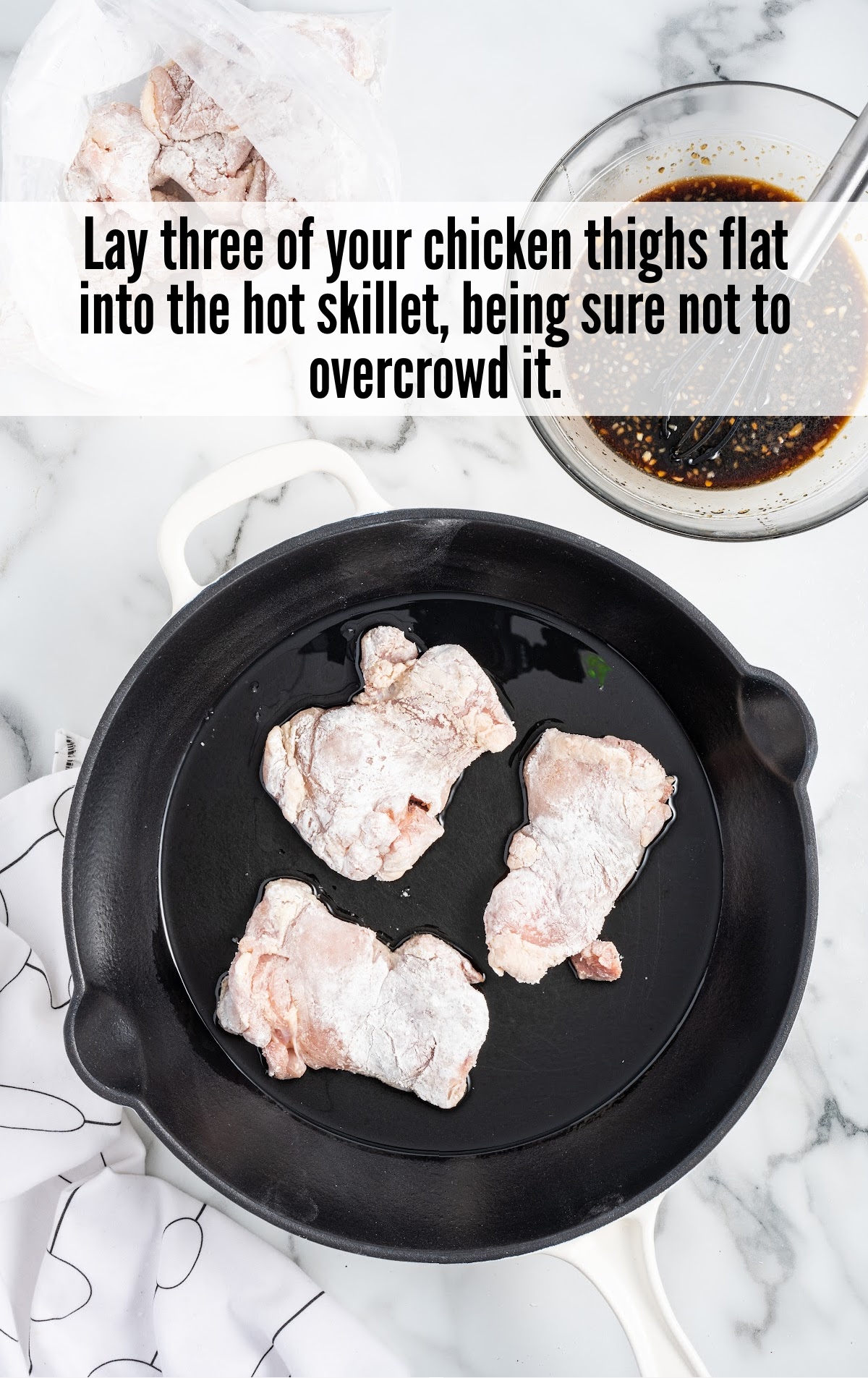 three chicken thighs in a skillet