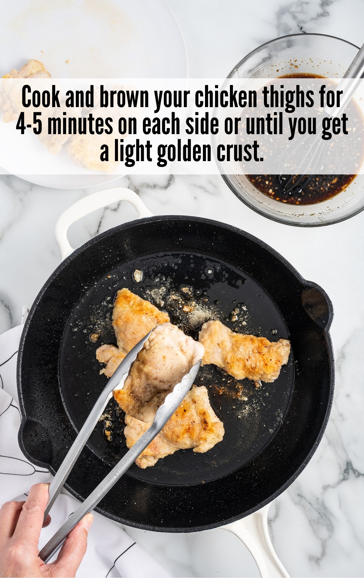 cooking the chicken thighs in a skillet