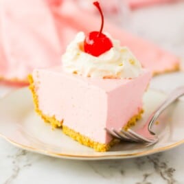 a slice of strawberry jello pie on a white plate.
