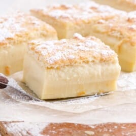 a spatula holding a piece of Magic Custard Cake