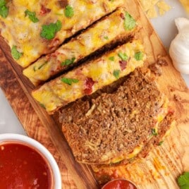 Mexican Meatloaf cut into slices on a wooden board