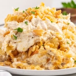 A white plate with a serving of Million Dollar Chicken Casserole on it.