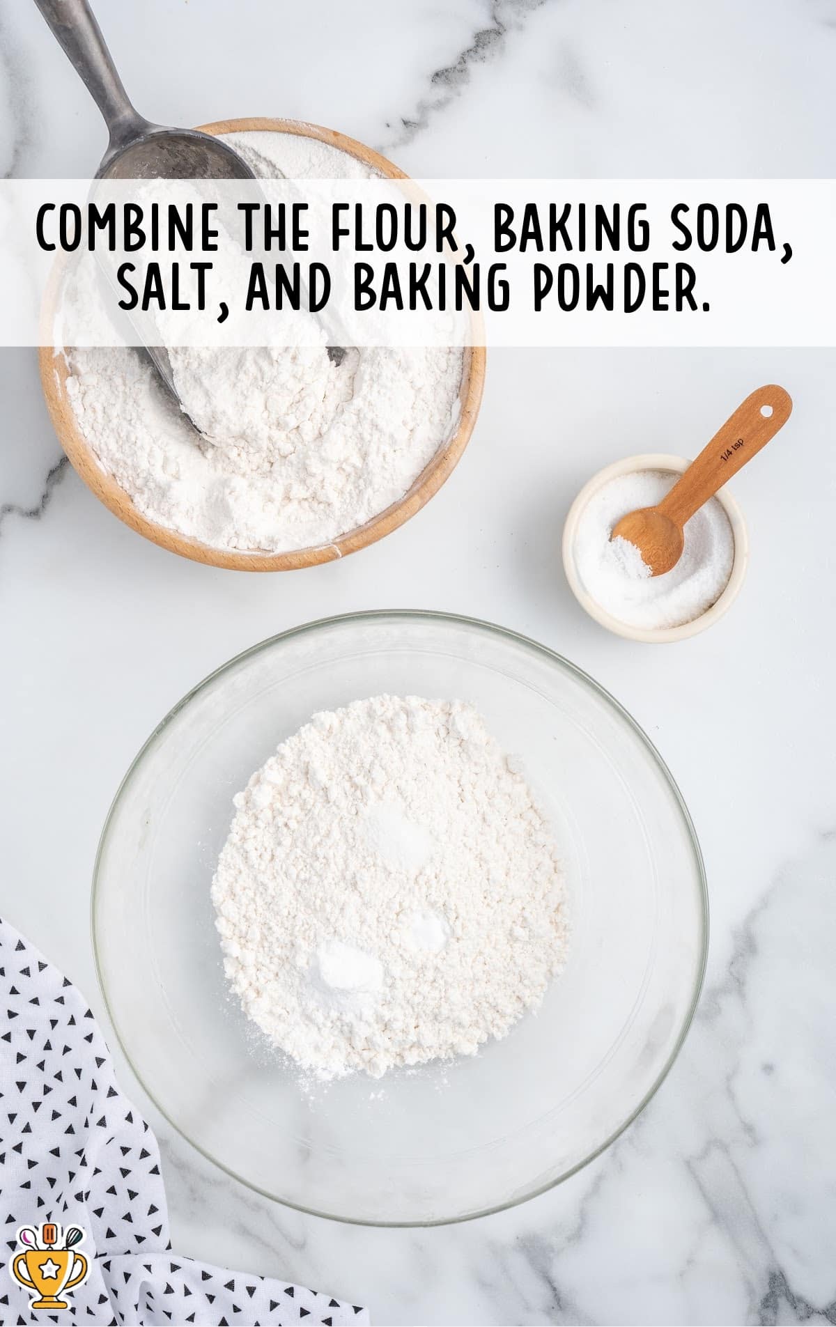Flour, baking soda, salt, and baking powder in a glass mixing bowl.