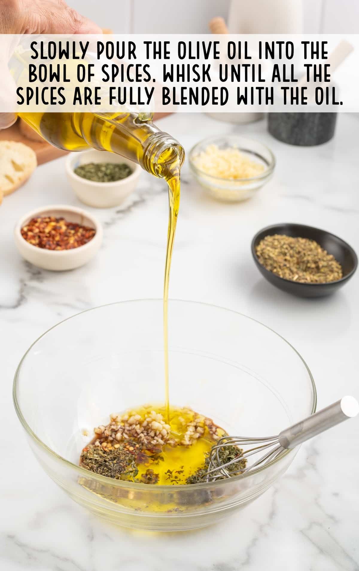 A person is pouring olive oil into the seasonings.