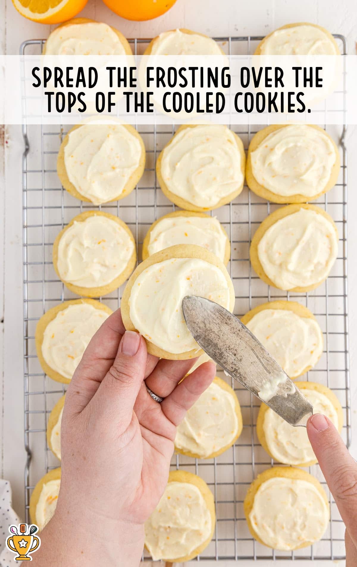 Spreading Frosting over the tops of the cooled cookies