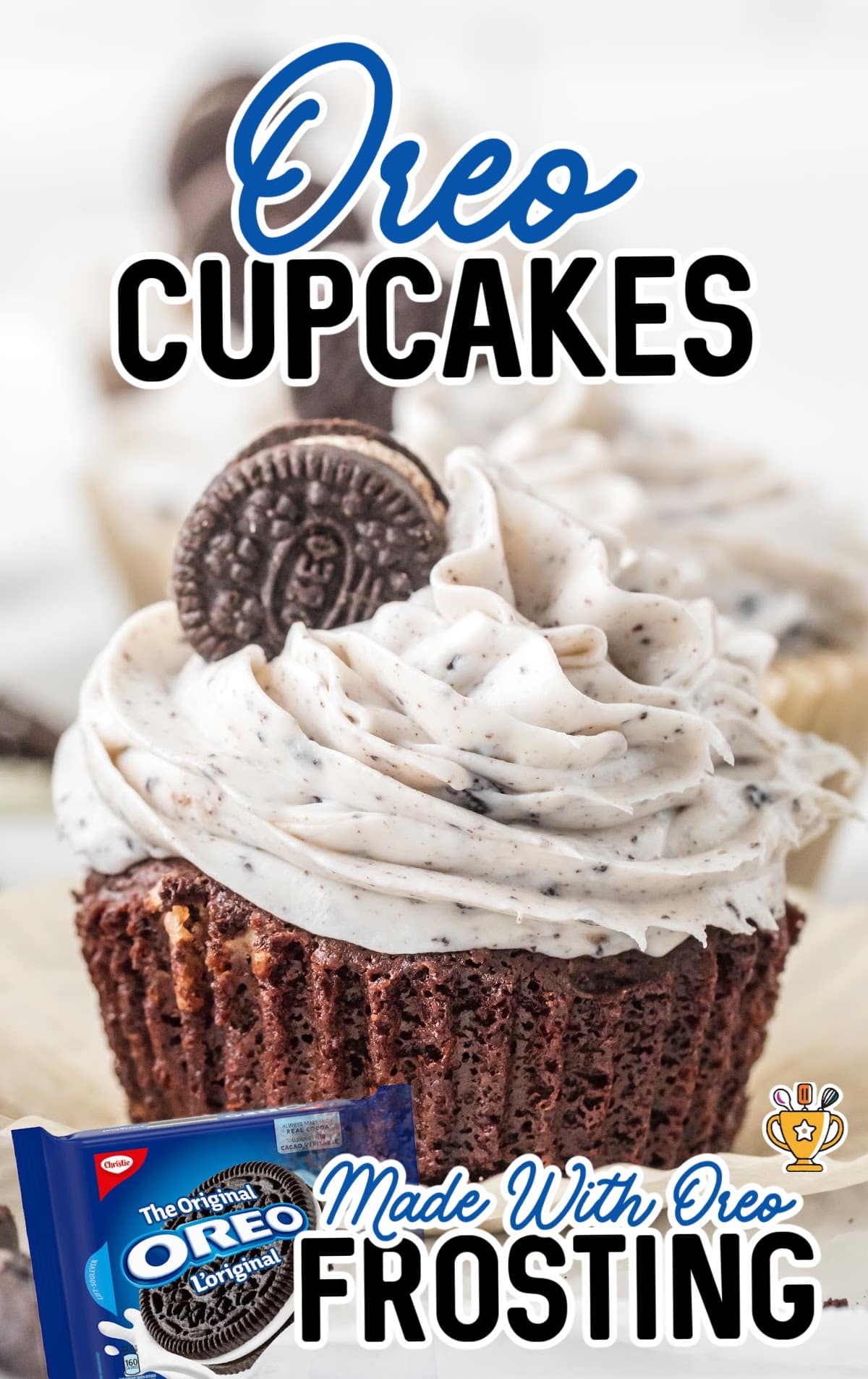 An Oreo cupcake with the wrapper removed, decorated with frosting and a mini Oreo.