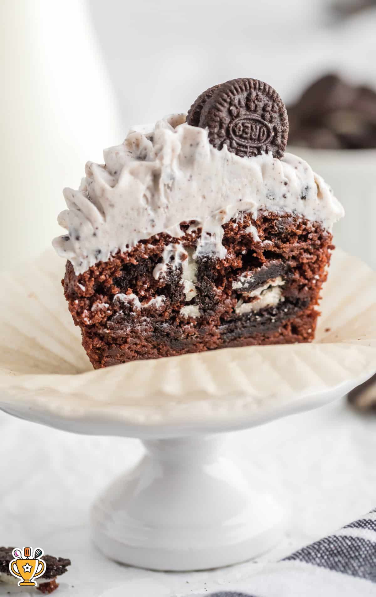A cut open oreo cupcake with big chunks of Oreo cookie showing.