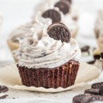 An Oreo Cupcake with cookies and cream frosting and a mini Oreo cookie.