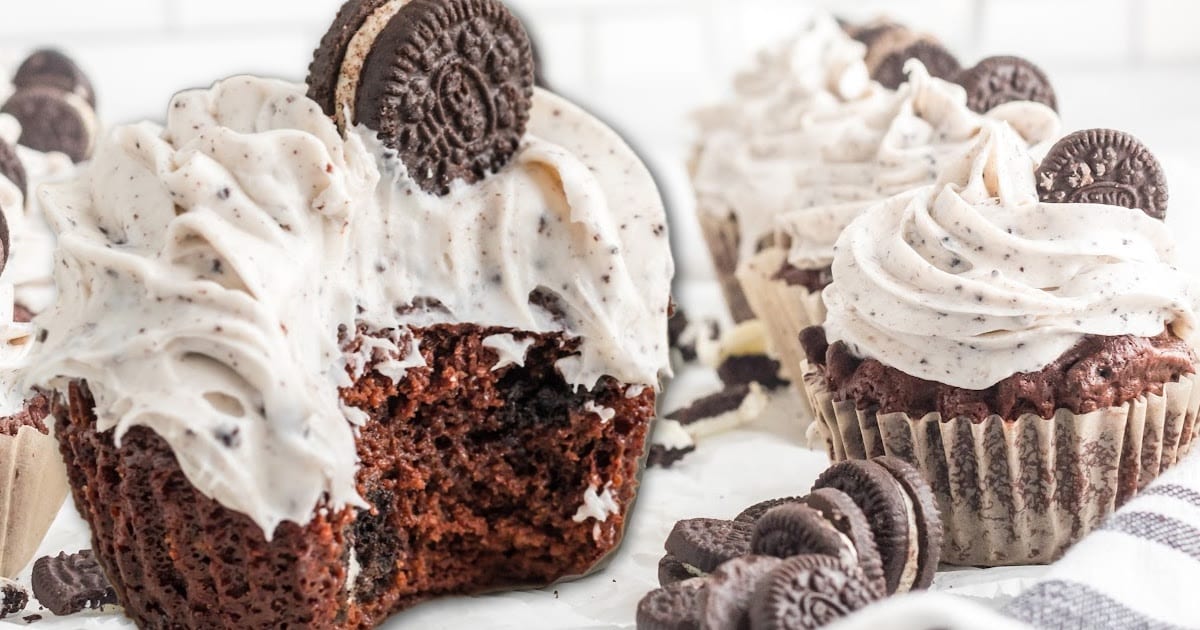 A close up of an Oreo cupcake with more Oreo cupcakes around it.