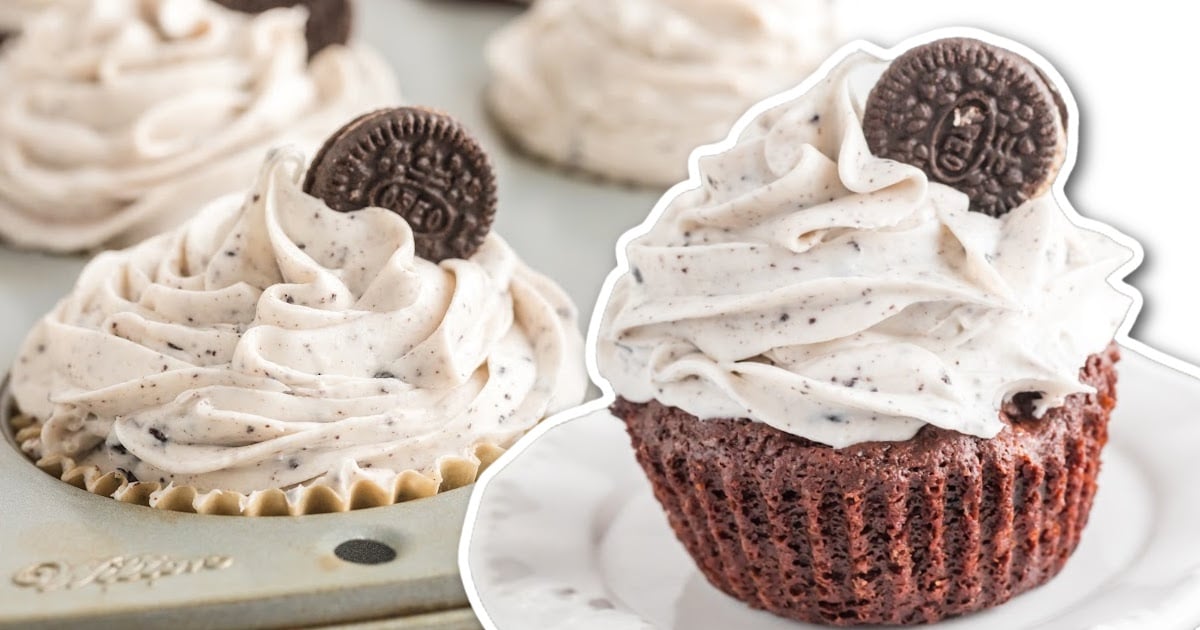 A cupcake tray full of decorated cupcakes and an Oreo cupcake on a white plate.