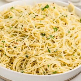 A bowl of Parmesan Noodles with parmesan on top.