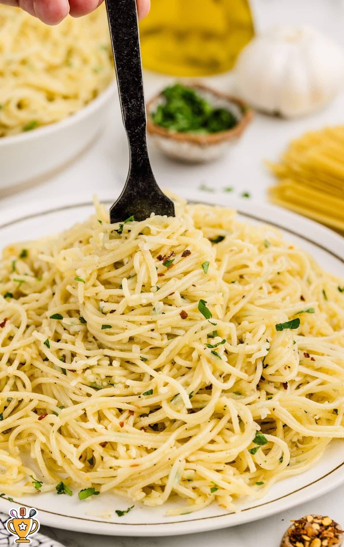 A plate of Parmesan Noodles with a fork in it.