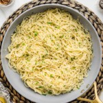 Parmesan Noodles is a skillet garnished with parsley and cheese.