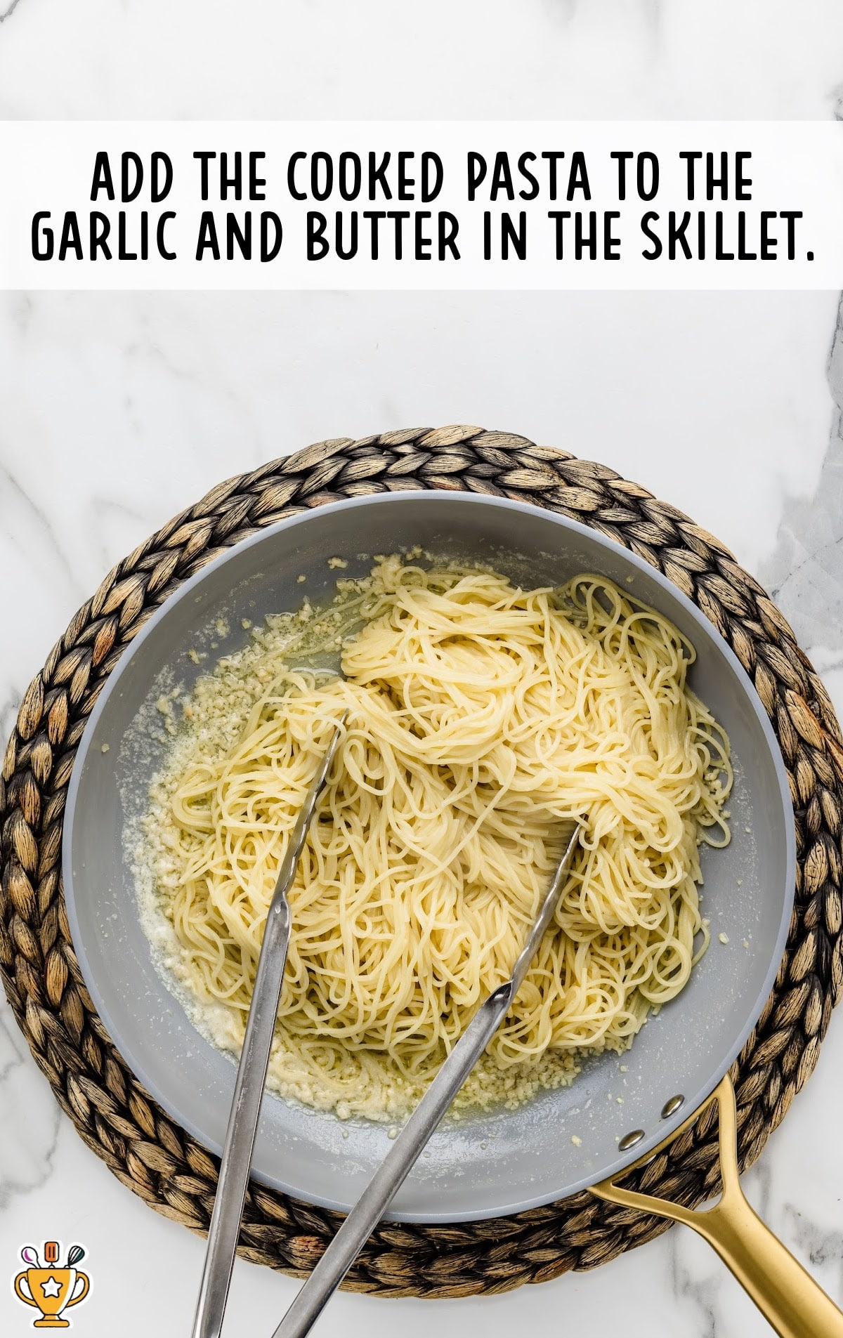 Cooked noodles added to the garlic butter.