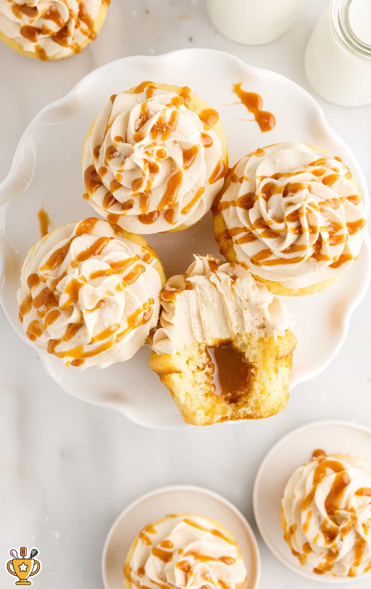 cupcakes on a white serving plate drizzled with caramel.