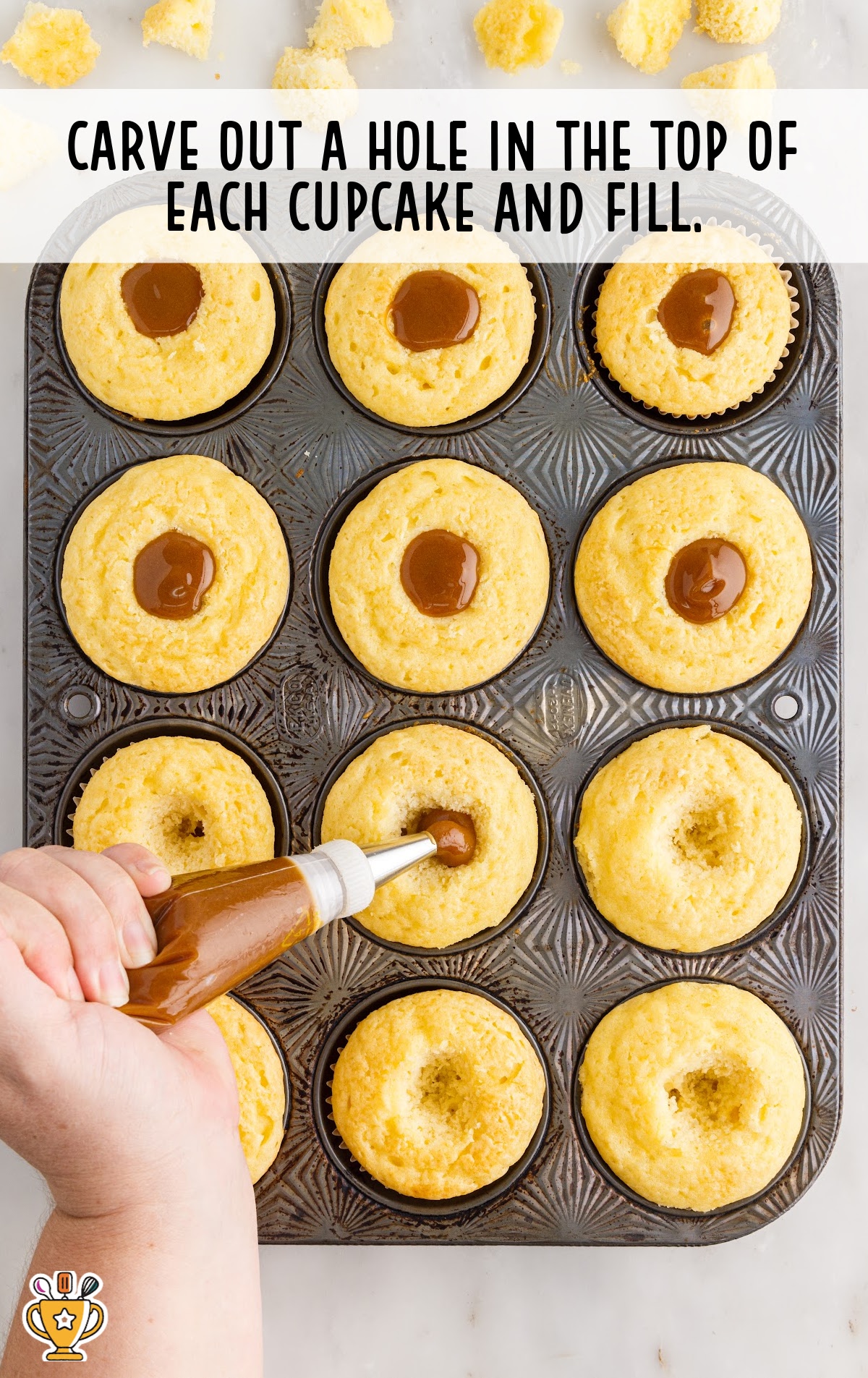 a piping bag fills each hole in the cupcakes with caramel.