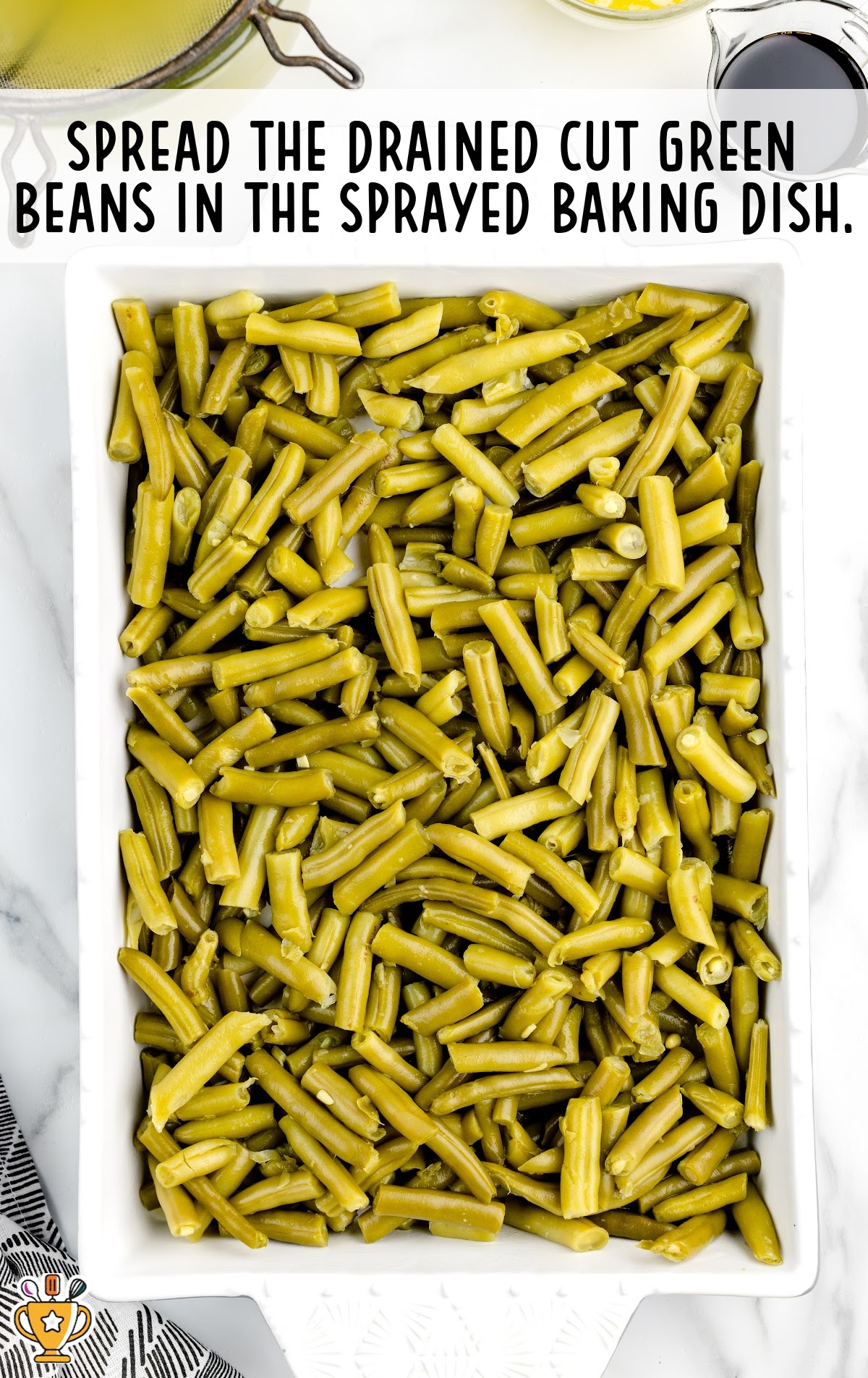 a casserole dish full of cut green beans.