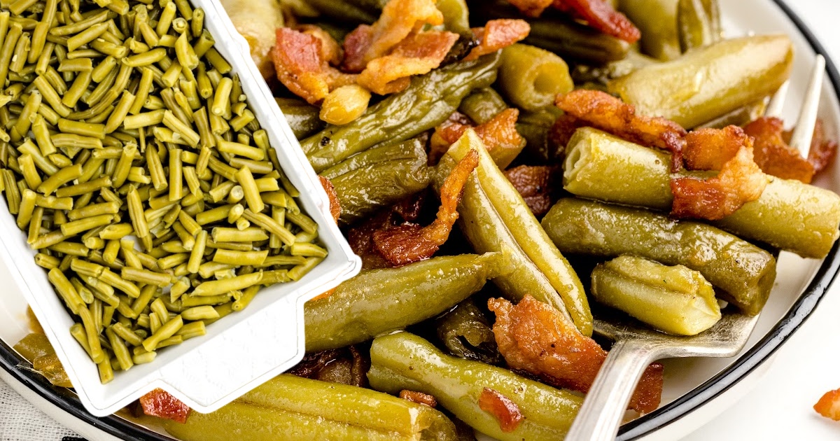 A serving plate and a fork next to a casserole dish full of beans.