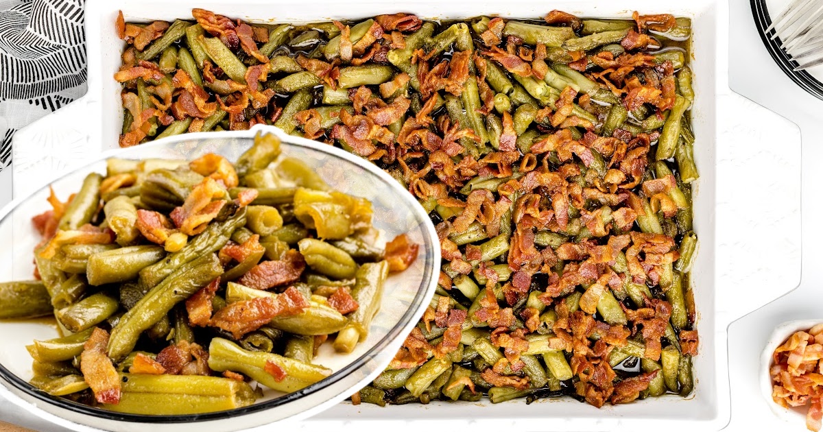 A casserole dish of green beans net to a serving plate of beans.