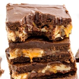 A stack of Snickers Brownie, the top one with a bite on it