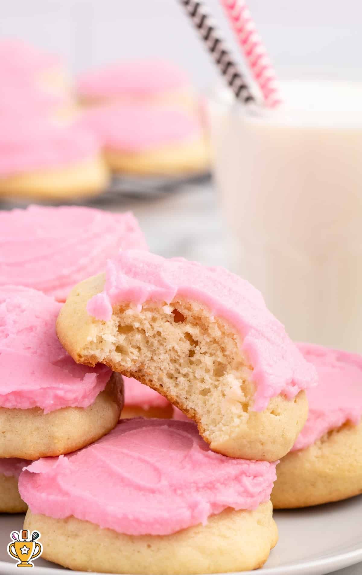 Sour Cream Cookies on a plate, one with a bite on it