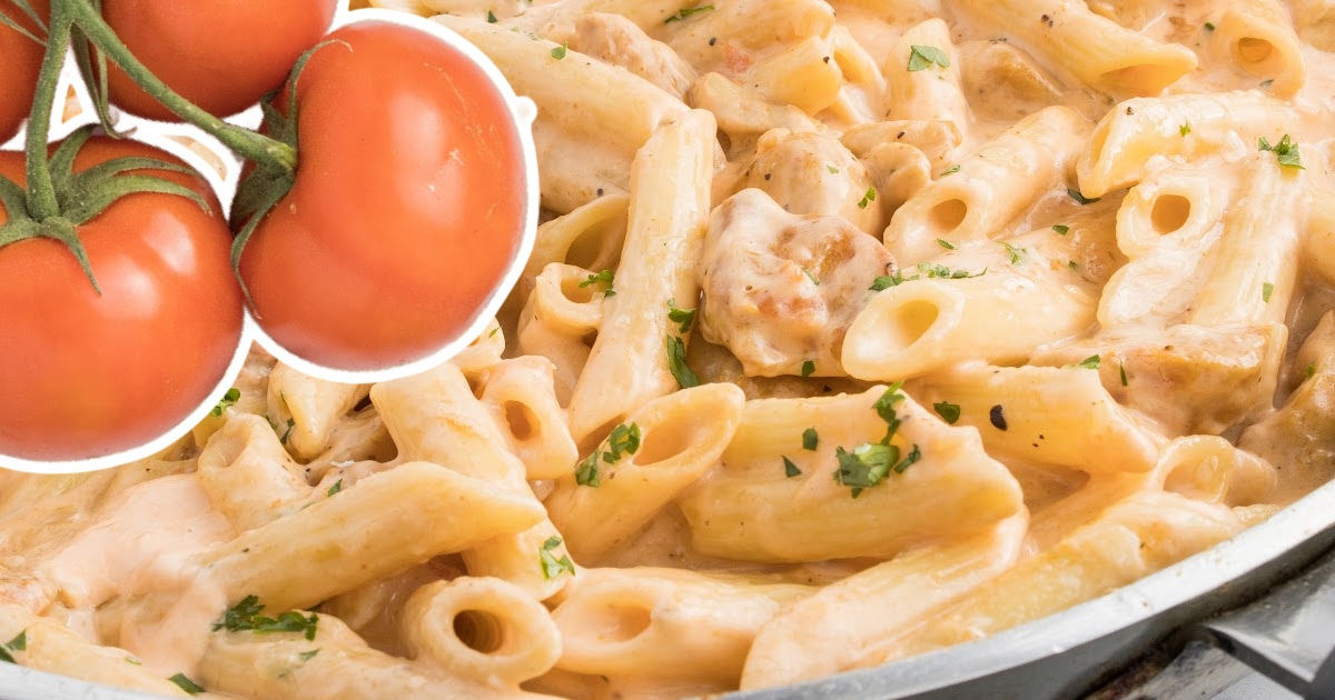 a close up photo of Spicy Chicken Pasta with some tomatoes on the side