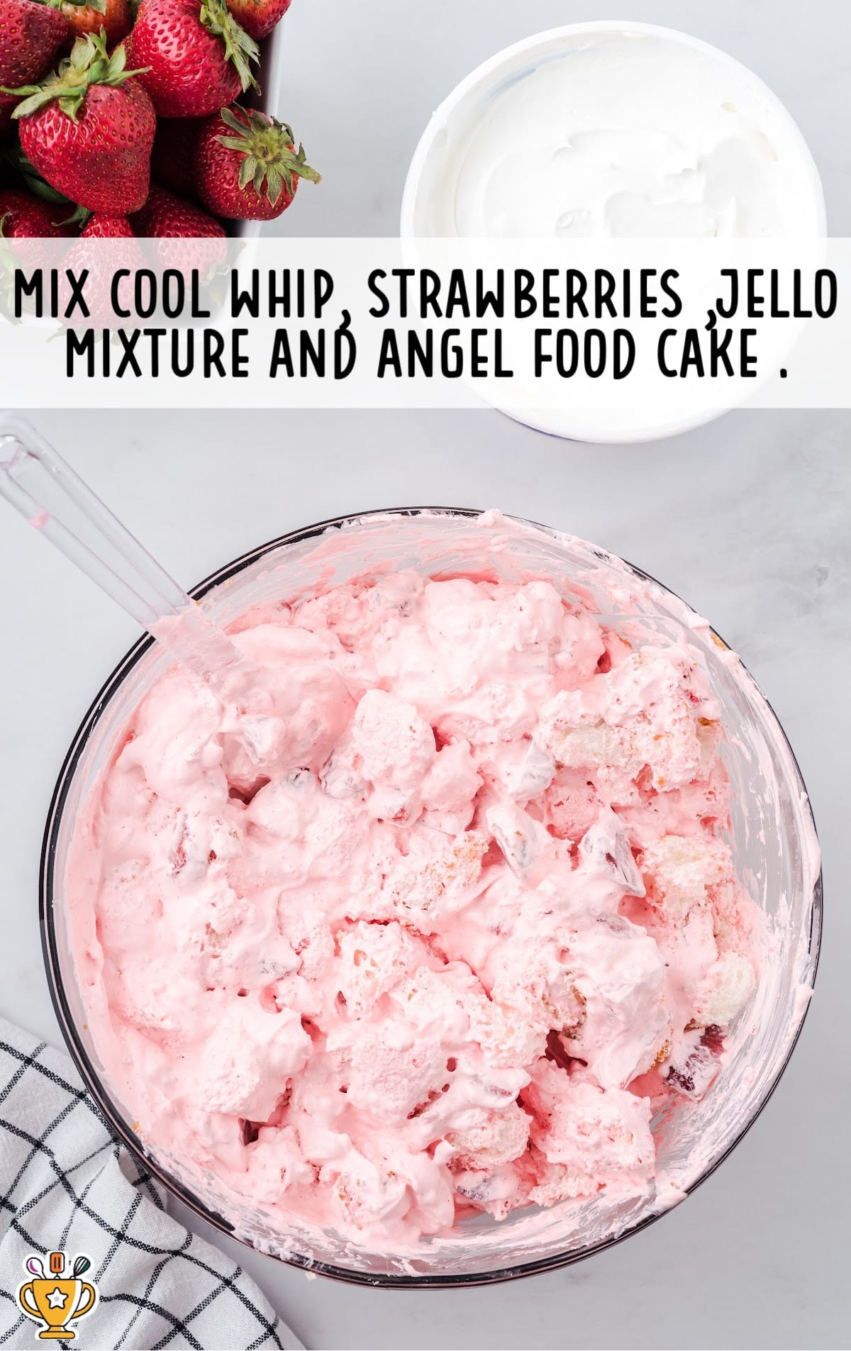 mixing cool whip, strawberries, jello mixture and angel food cake in a bowl