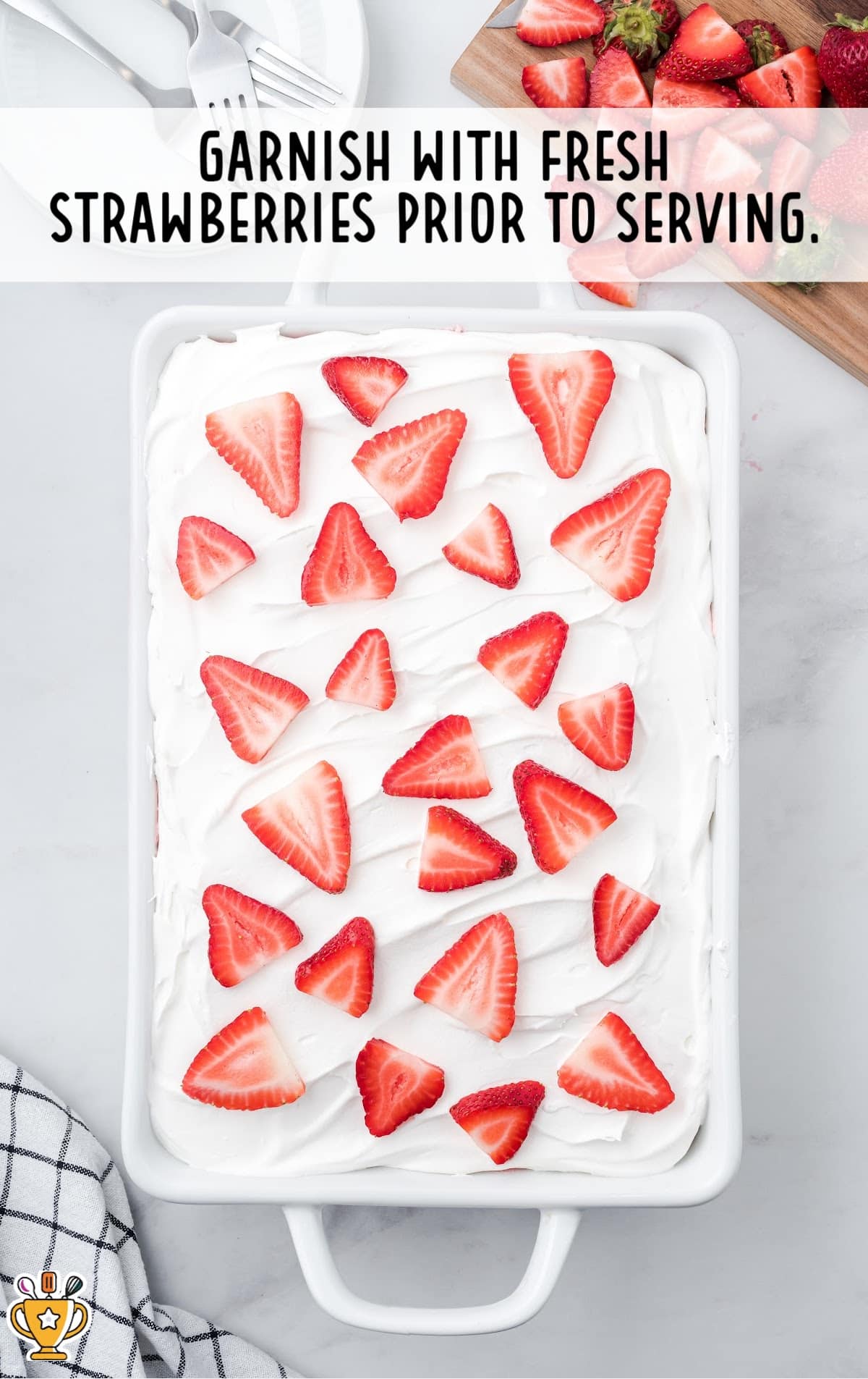 Strawberry Angel Food Cake in a baking tin, garnished with strawberries