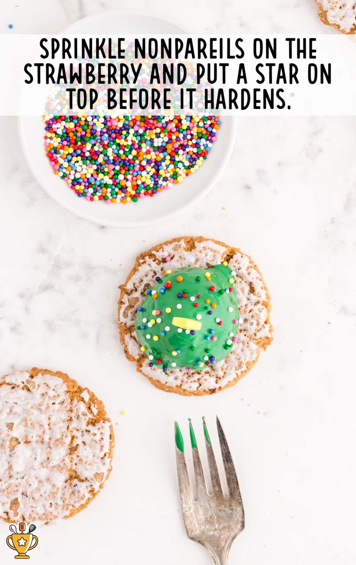 A Strawberry Christmas Tree with a fork and some sprinkles in a bowl