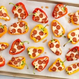 A baking tray full of baked Mini Pepper Pizzas.