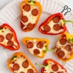 A white dinner plate of Mini Pepper Pizzas.