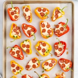 A baking pan covered in Mini Pepper Pizzas.