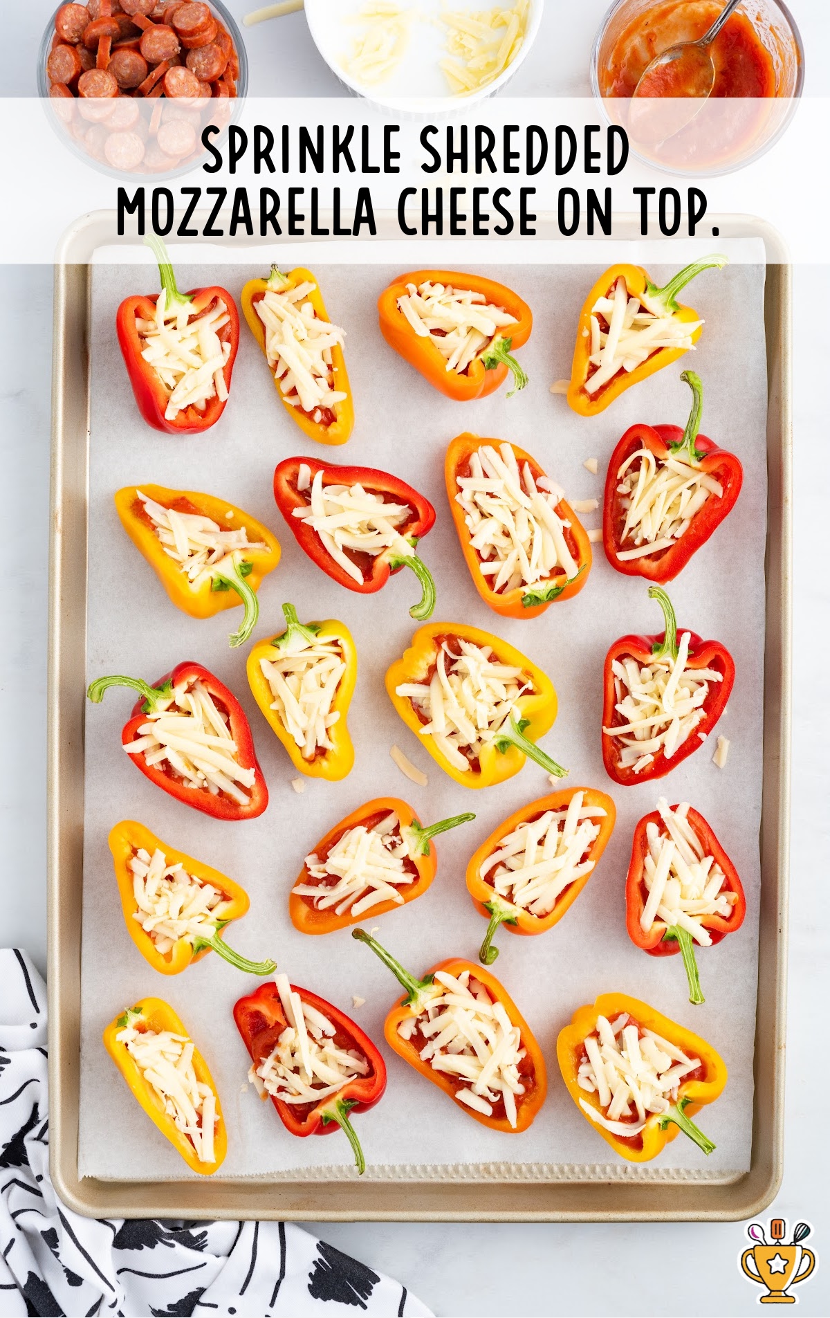 Mini peppers covered in sauce and shredded cheese.