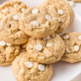 a white plate covered in White Chocolate Chip Cookies